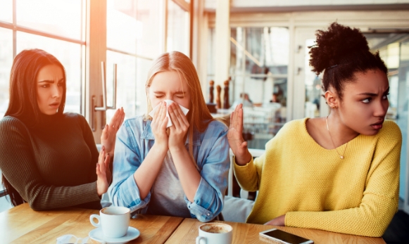 A-Woman-Suffering-from-Influenza-Sneezing-in-a-Tissue-Paper