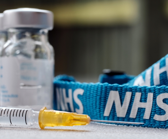 Vial-of-Flu-Vaccine-with-a-Syringe-and-a-NHS-Band