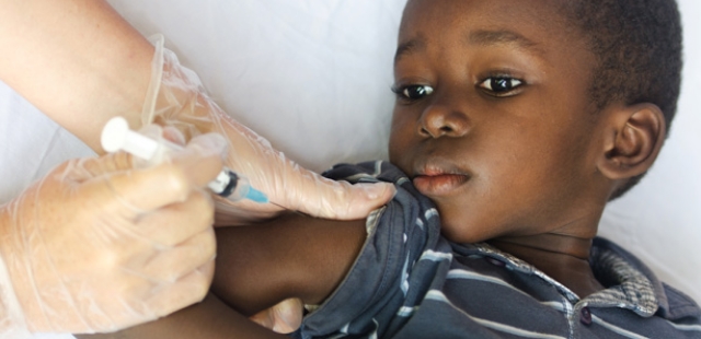 a doctor administering a cholera vaccine to a child to safeguard against the disease