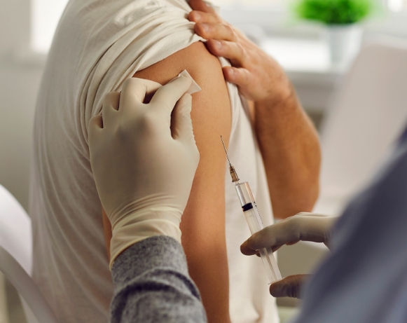 doctor giving pneumococcal vaccine to a patient in a clinic