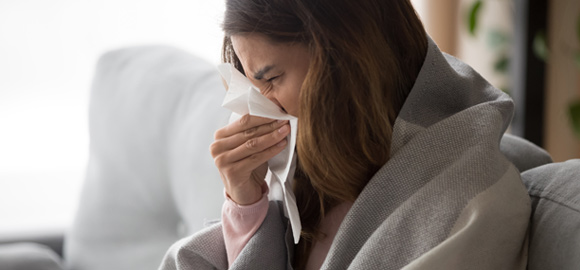 Woman-Suffering-from-Viral-Infection-Blowing-Running-Nose-in-a-Tissue-Paper