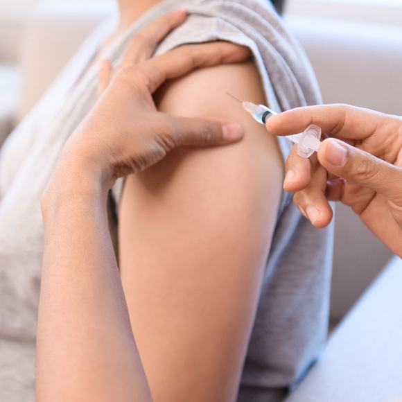 A woman receiving important hajj vaccines on her arm